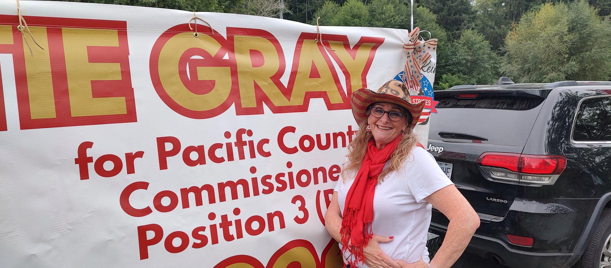 Pattie Gray with campaign banner in Pacific County